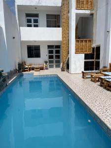 een zwembad voor een huis bij Olas inn in Asia