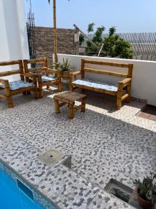 a group of benches sitting next to a pool at Olas inn in Asia