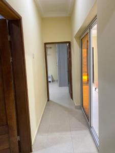 an empty hallway of a house with a door open at Dija Residence in Bijilo