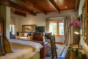 a bedroom with a bed and a living room at Webersburg in Stellenbosch