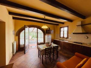 a kitchen with a table and a dining room at Borgo degli Orti in Montaione