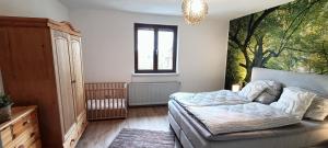 a bedroom with a bed and a large painting on the wall at Ferienwohnung Urlaubszeit in Illingen