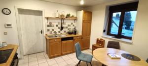 a kitchen with a table and a sink and a table and chairs at Ferienwohnung Urlaubszeit in Illingen