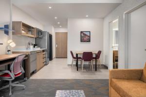 a kitchen and living room with a table and chairs at Home2 Suites By Hilton Vaughan Toronto On in Vaughan