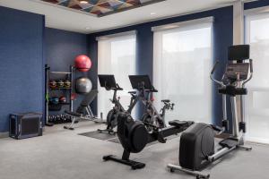 a gym with several tread machines in a room at Home2 Suites By Hilton Vaughan Toronto On in Vaughan