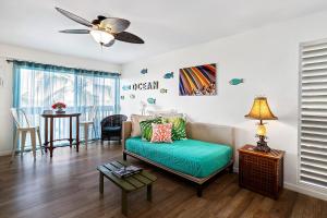 a living room with a couch and a ceiling fan at Kona Mansions#301 in Kailua-Kona +17 photos