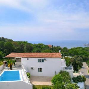a large white house with a swimming pool at Villa Sea La Vie in Utjeha