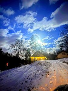 a snow covered road with the sun in the sky at Kousek ráje in Třinec
