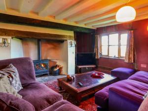 a living room with two couches and a fireplace at Town Farm in Eye