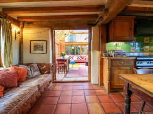a living room with a couch and a kitchen at Town Farm in Eye