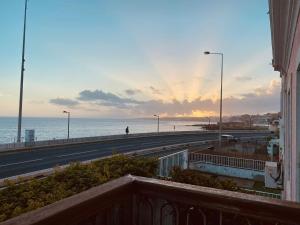 a view from a balcony of a road and the ocean at Ocean Gate Palace in Caxias