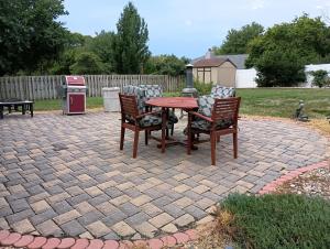 a patio with a table and chairs and a stove at Poplar Estate in Lincoln