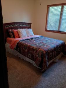 a bedroom with a bed with a quilt on it at Poplar Estate in Lincoln