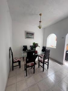 a dining room with a table and chairs at Hostal Los Robles in Pasto +2 photos