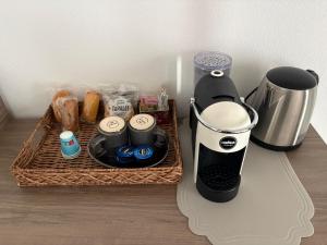 a coffee maker sitting on a counter next to a tray of food at Scossicci Del Sole in Loreto