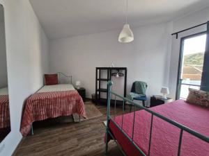 a bedroom with two beds and a window at Estrela do Frade in Maia