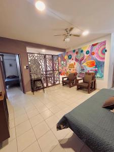 a room with a bed and a painting on the wall at Espacio Planetaria in Córdoba