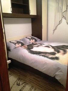 a bedroom with a bed with two cats on it at Kuća za odmor Vukas in Kupres