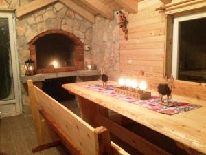 a wooden table with candles on it in a fireplace at Kuća za odmor Vukas in Kupres