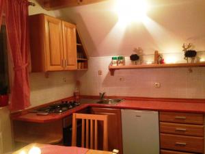 a kitchen with a sink and a stove top oven at Kuća za odmor Vukas in Kupres +9 photos