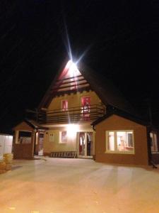 a building with a light on top of it at night at Kuća za odmor Vukas in Kupres