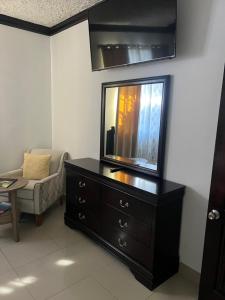 a living room with a dresser with a mirror on it at Steps Away from Adventure -2bedroom & 2 Bath in Turtle Cove