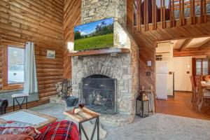 a living room with a fireplace with a flat screen tv at 2 Br Plus Loft: Hawthorne Valley 4 in Snowshoe