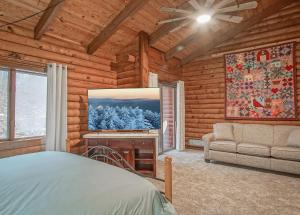 a bedroom in a log cabin with a bed and a couch at 2 Br Plus Loft: Hawthorne Valley 4 in Snowshoe