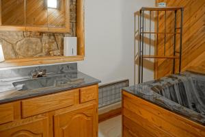 a bathroom with a sink and a wooden counter at 2 Br Plus Loft: Hawthorne Valley 4 in Snowshoe +22 photos