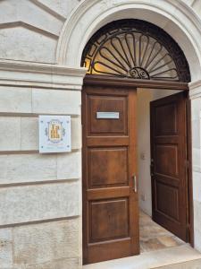 an entrance to a building with a wooden door at Casa Tanina in Bitonto