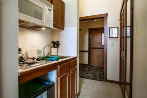 a kitchen with a sink and a microwave at Allegheny Springs 414: Junior Studio Slopeside in Snowshoe +11 photos