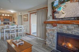 a living room with a fireplace with a tv at Rimfire 151- 152 Unique 2 Br Condo in Snowshoe