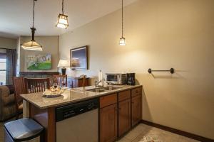 a kitchen with a sink and a microwave at Soaring Eagle 414 in Snowshoe +26 photos