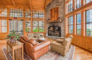 a living room with a couch and a fireplace at Soaring Eagle 414 in Snowshoe