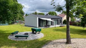a house with two benches in a yard at Domek Prosetin244 in Prosetín