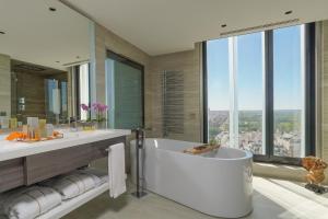 a bathroom with a tub and a large window at VP Plaza España Design in Madrid