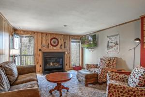 a living room with a couch and a fireplace at Powderidge 2 -Slope Side, Spacious Deck in Snowshoe