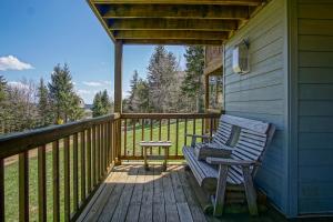 a porch with a bench and a table on a deck at Powderidge 2 -Slope Side, Spacious Deck in Snowshoe