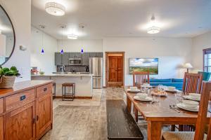 a kitchen and living room with a wooden table and chairs at Soaring Eagle #403: 2 Bedrooms, 2 Full Baths in Snowshoe