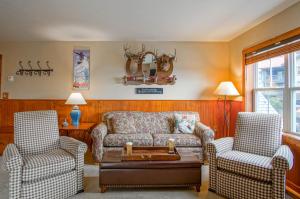 a living room with a couch and two chairs at Highland House #102-104: 2Br: 2 Bath in Snowshoe