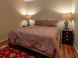 a bedroom with a bed with two night stands and two lamps at Stemwinder 6B 1 Bedroom, 1 Full Bath, Slope Side in Slaty Fork +5 photos