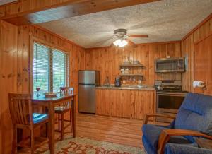 a kitchen with wooden cabinets and a table and a couch at Stemwinder 6B 1 Bedroom, 1 Full Bath, Slope Side in Slaty Fork