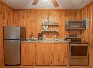 a kitchen with a stainless steel refrigerator and a microwave at Stemwinder 6B 1 Bedroom, 1 Full Bath, Slope Side in Slaty Fork
