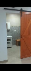 a door leading into a room with a kitchen at Loft Urbano Pilar in Del Viso