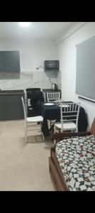 a bedroom with a desk and a bed and chairs at Loft Urbano Pilar in Del Viso