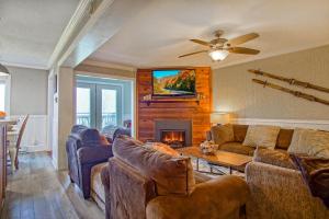 a living room with couches and a fireplace at Summit 107B 3Br Condo in Snowshoe
