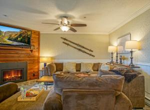 a living room with a couch and a fireplace at Summit 107B 3Br Condo in Snowshoe