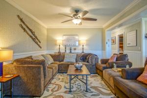 a living room with couches and a ceiling fan at Summit 107B 3Br Condo in Snowshoe