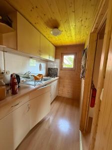a kitchen with white cabinets and a yellow ceiling at Eulennest in Reimershagen