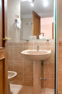 a bathroom with a sink and a mirror at Salto Grande Hotel in Punta del Este